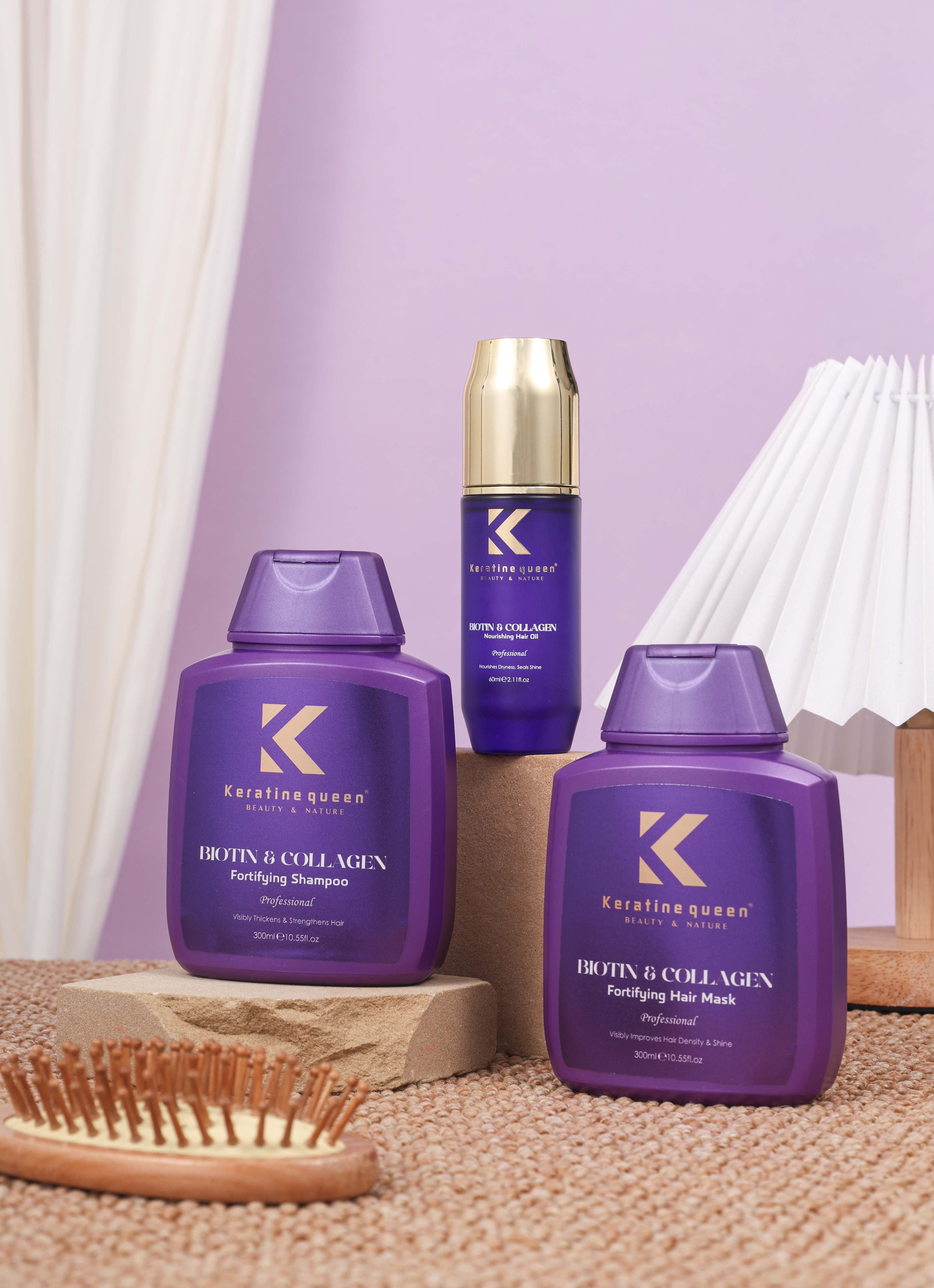 Purple Keratine Queen Biotin and Collagen hair care set on stone blocks with hairbrush.